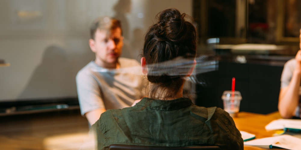 People sitting at a table at a meeting